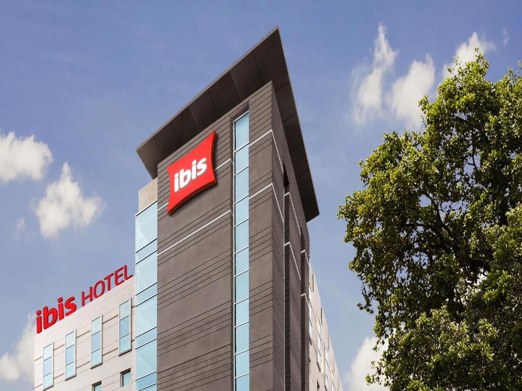 a tbs hotel building with a sign on it at ibis Hyderabad Hitec City - An Accor Brand in Hyderabad