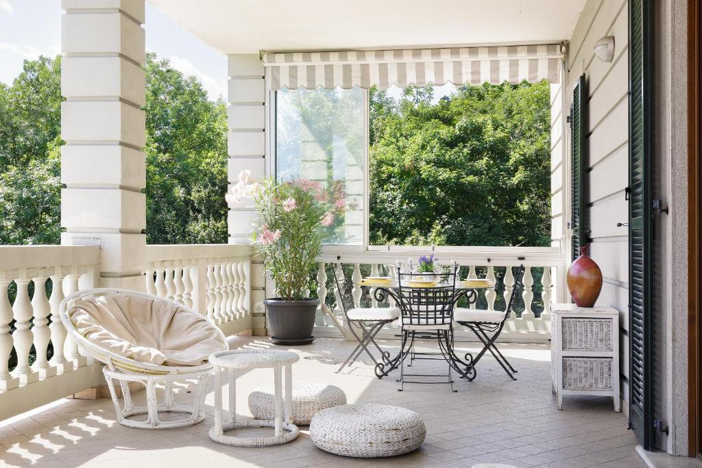 a porch with a table and chairs on it at La Casa di Alice in Tavernerio