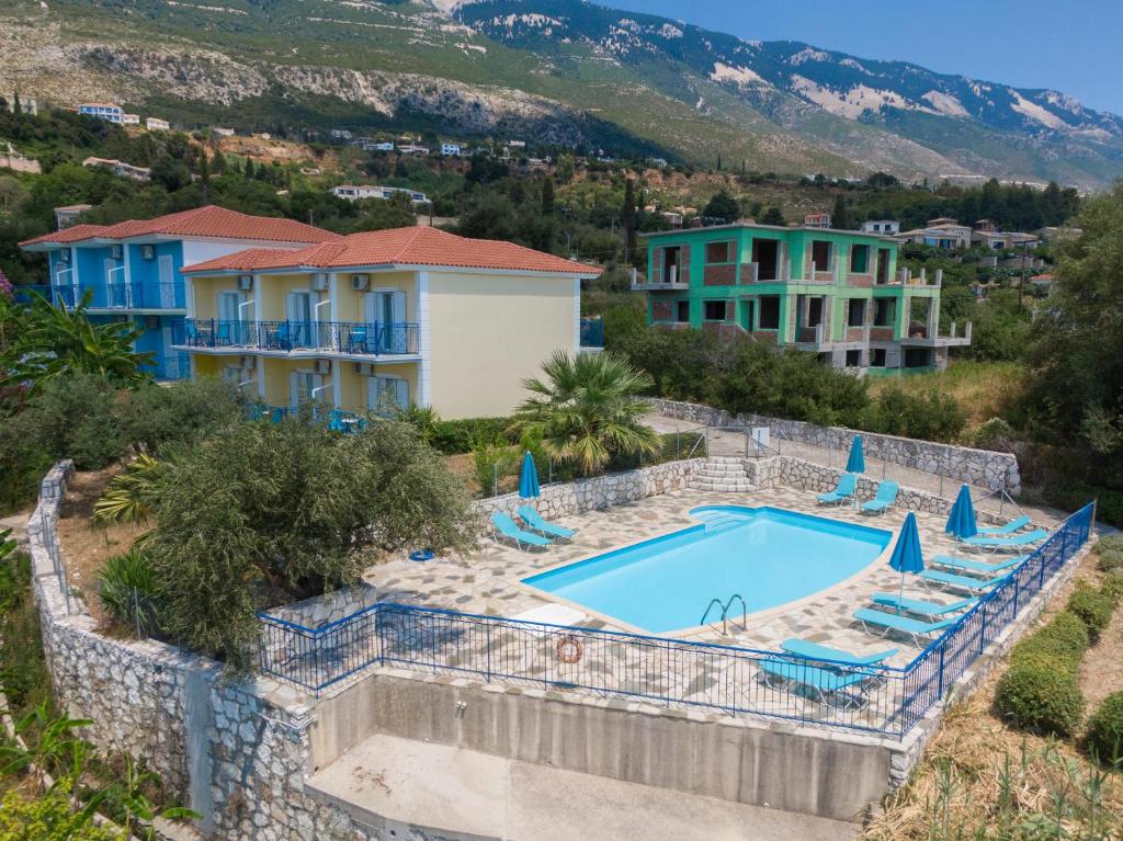 a villa with a swimming pool and a resort at Milos Studios in Lourdhata