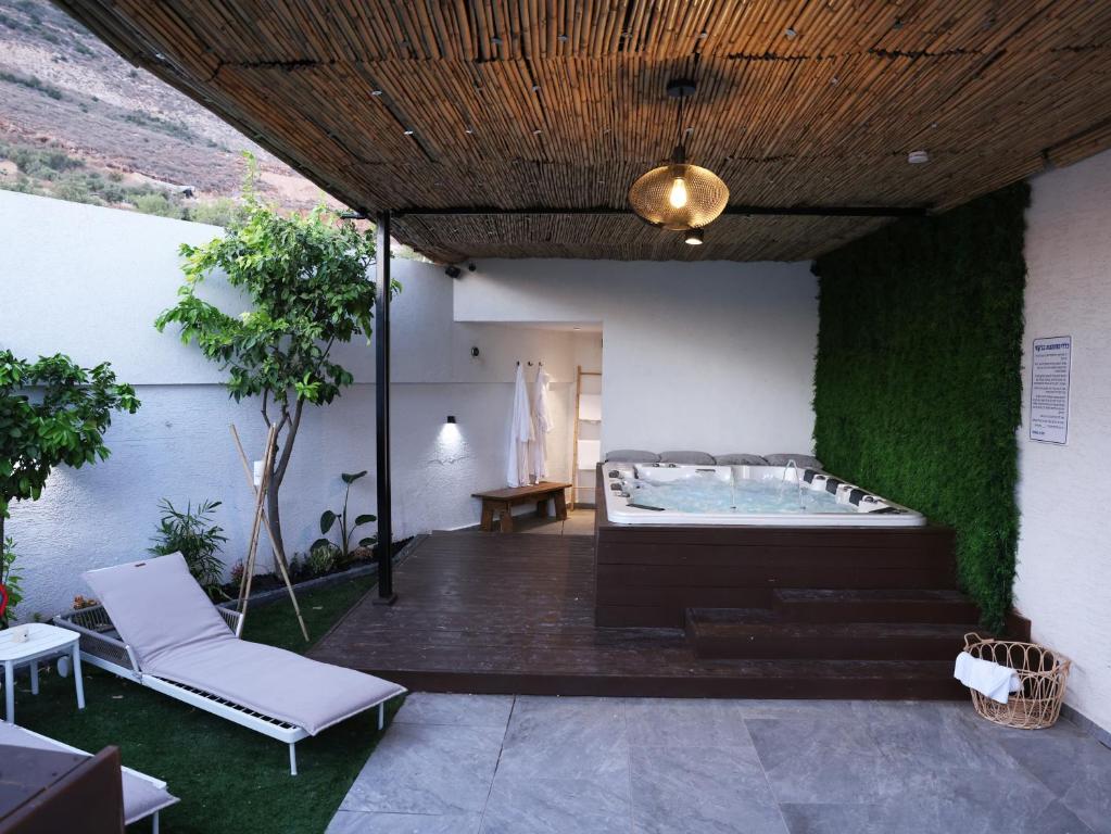 - un bain à remous dans une pièce dotée d'un mur vert dans l'établissement וילה Mandala אירוח&אירועים, 