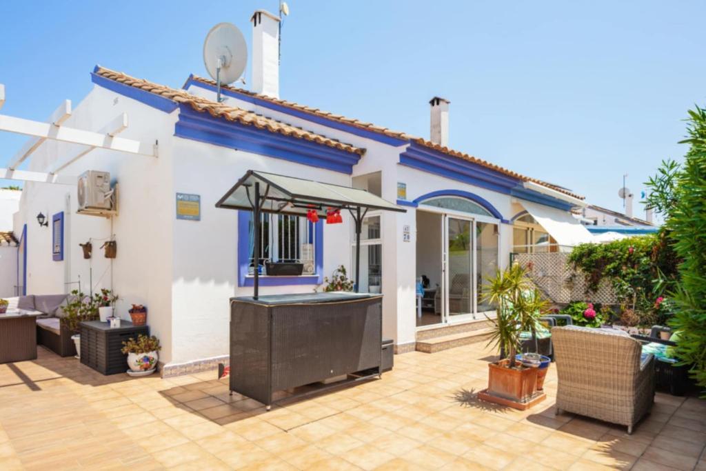 a house with a patio with a bird feeder at The Beach house in El Verger