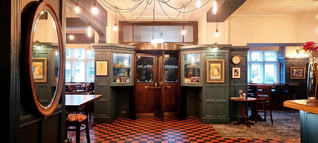 un ristorante con un bar con uno specchio e tavoli di The Royal Oak, Settle a Settle