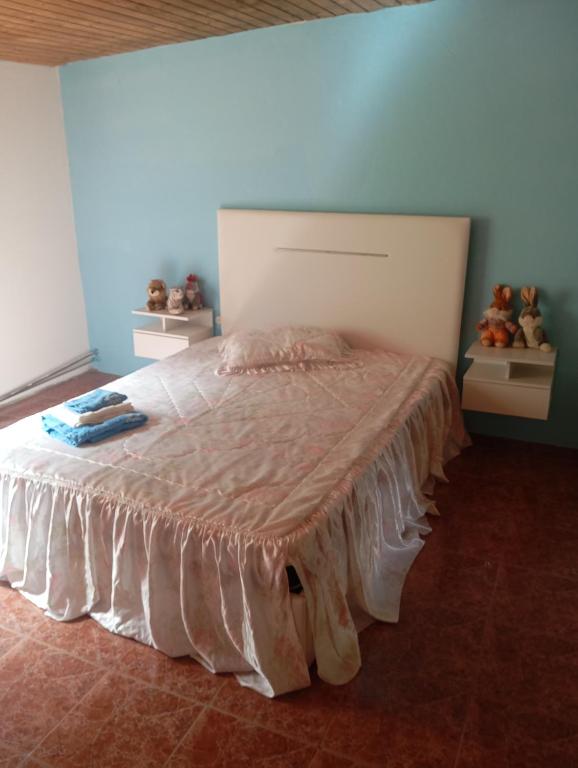 a bedroom with a large bed with a blanket on it at O cantinho d'abelheira 