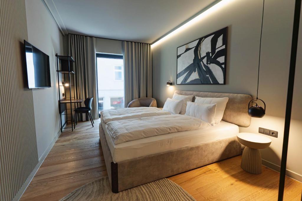 a bedroom with a large bed and a desk at Conlon House Lower East Side in Munich