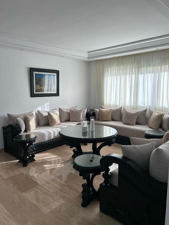 a living room with a couch and a table at Modern 2BR Apartment Tangier Center with Air Conditioning and WiFi in Tangier