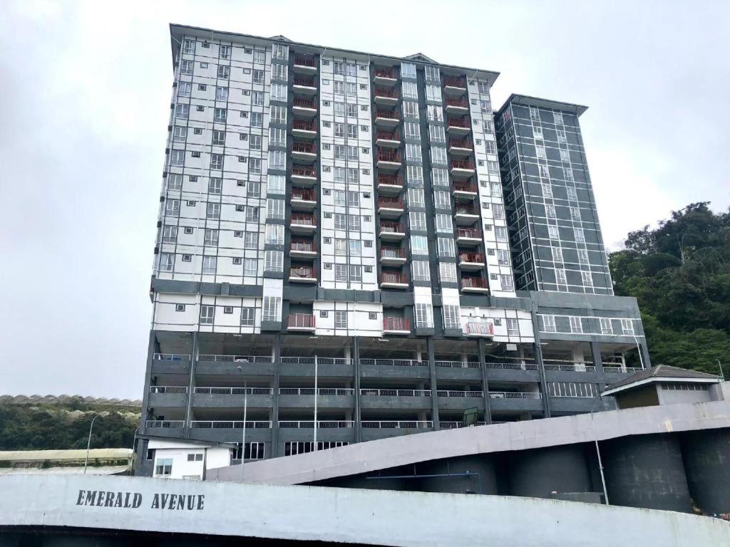 a tall building with a sign in front of it at CAMERON HIGHLAND CENRTUM BRINCHANG Homestay By Dcozy 6-7pax in Brinchang