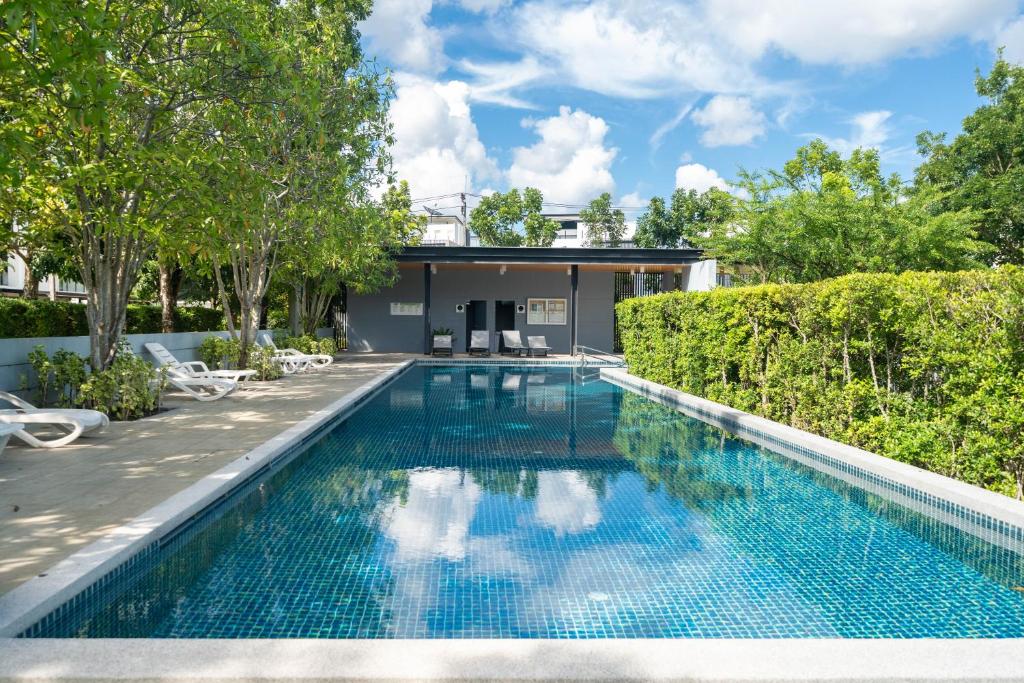 a swimming pool in the backyard of a house at Laguna Park 10 minutes walk to Bangtao Beach in Phuket