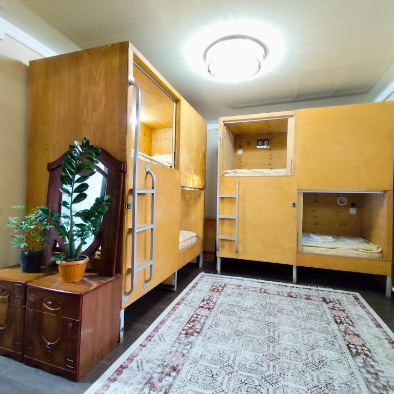 a room with some bunk beds and a rug at Megahostel in Osh