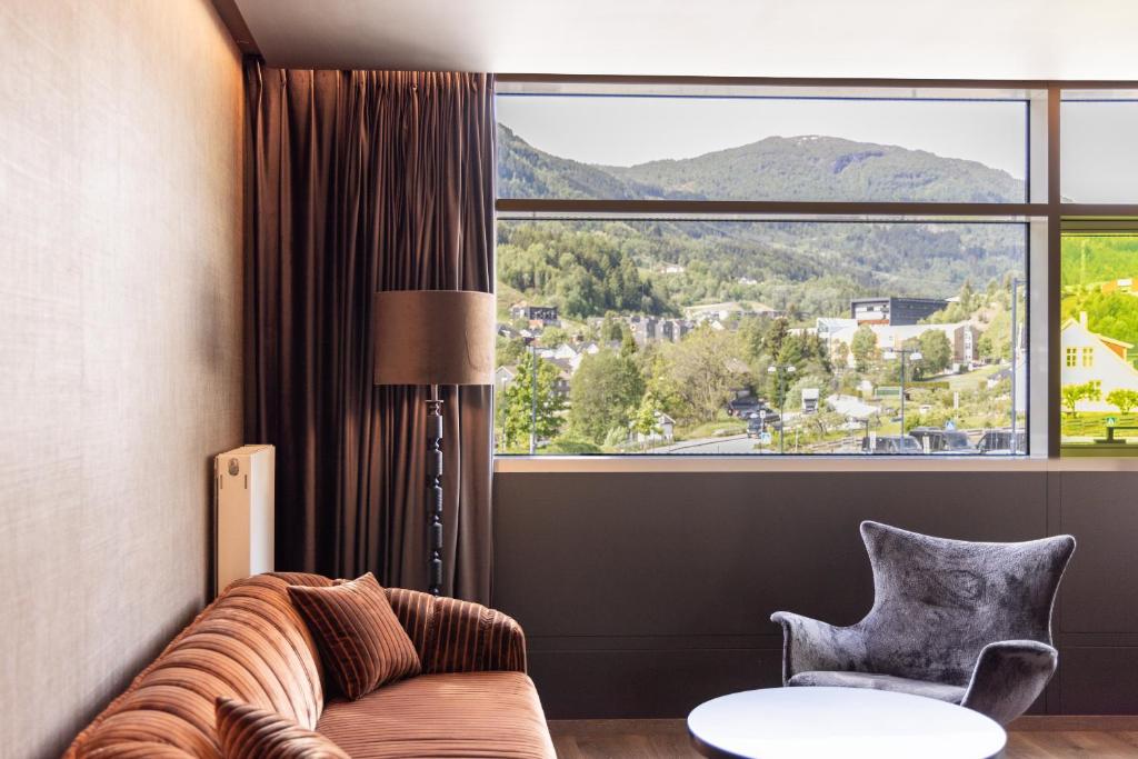 a living room with a couch and a large window at Quality Hotel Sogndal in Sogndal