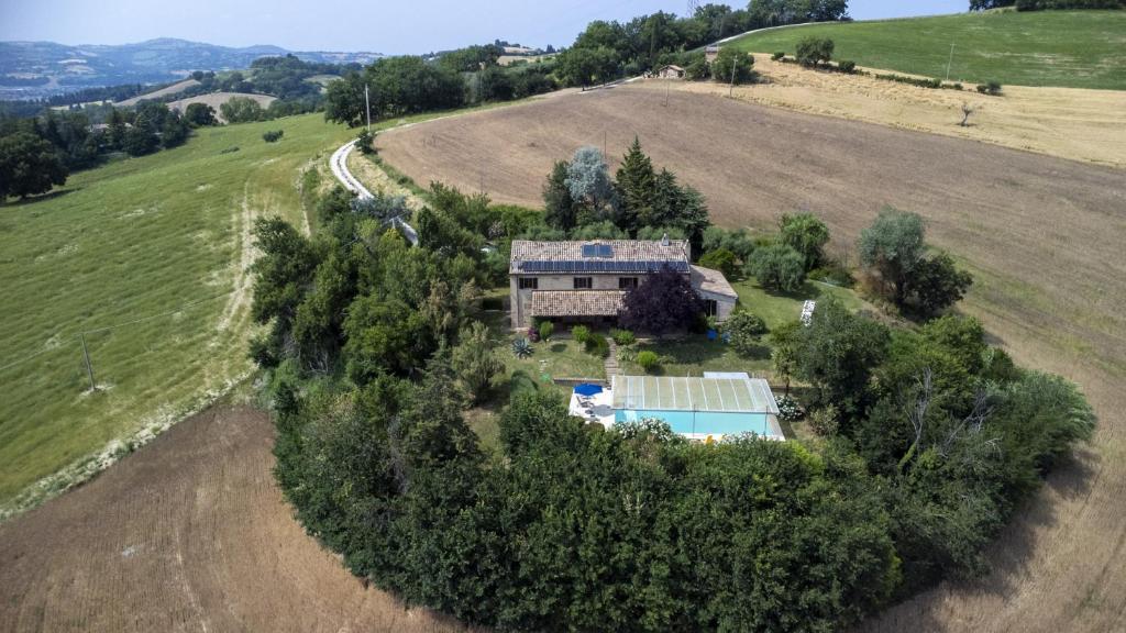 an aerial view of a house in a field at Ca Lucciola 12 by Marche Holiday Villas in Montemaggiore al Metauro