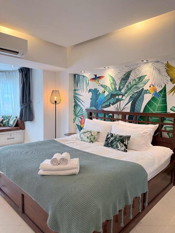 a bedroom with a large bed with two towels on it at Hillside Condo 2 in Chiang Mai