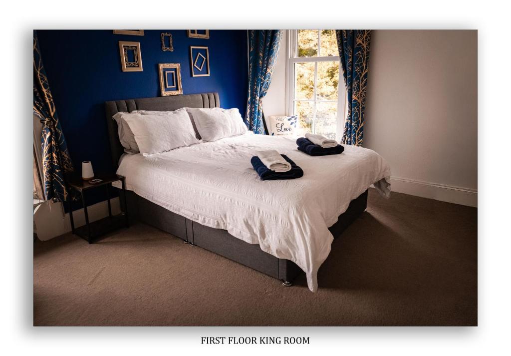 a bedroom with a bed with two towels on it at Clarefoot Cottage in Moffat