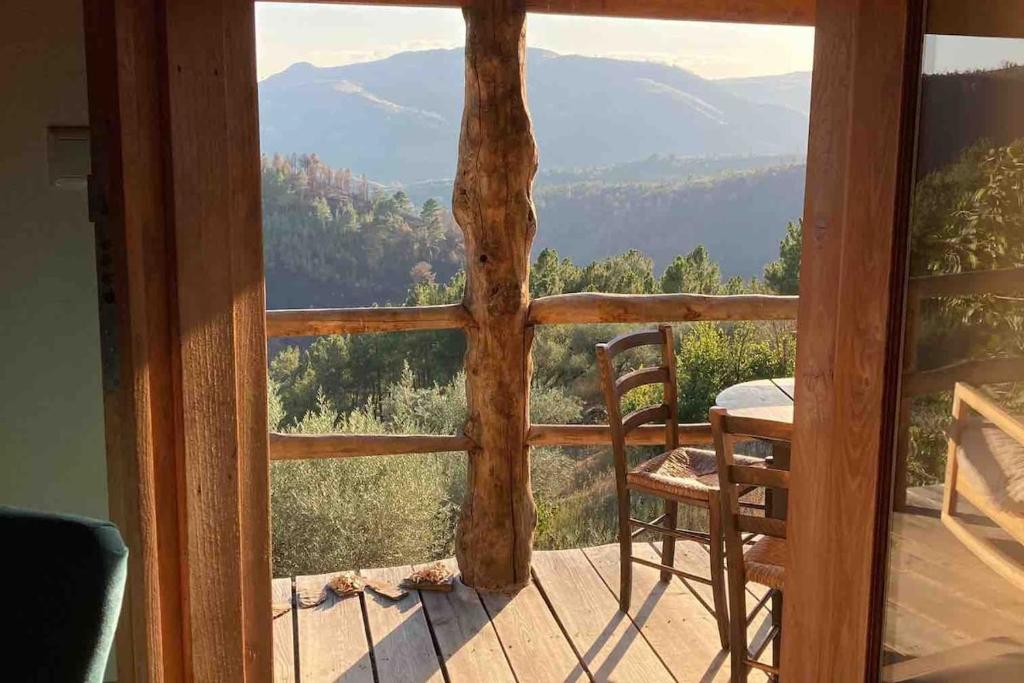 - Balcón de madera con mesa y silla en Casa dos Figos vistas fantásticas, en Vinhais
