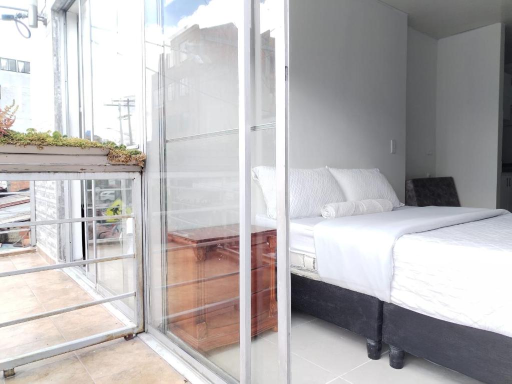 Postel nebo postele na pokoji v ubytování Apartahotel Barú - Usaquén