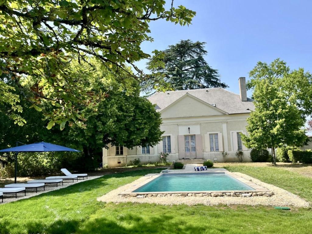 a house with a swimming pool in the yard at Domaine du Cèdre Eternel in Saint-Colomb-de-Lauzun
