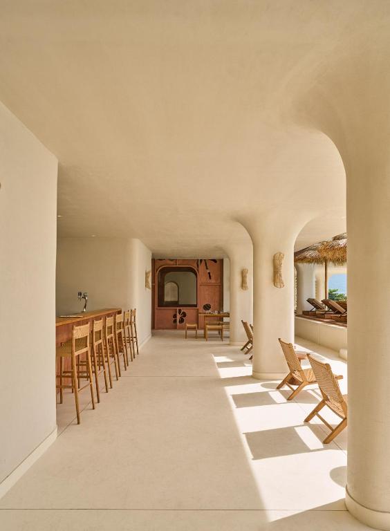 A bright dining corridor offers counter seating and a view toward the pool area.
