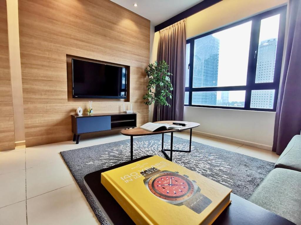 a living room with a couch and a tv at Suasana Suites Johor Bahru 2 Bedroom 6pax with Pool and Free Parking in Johor Bahru