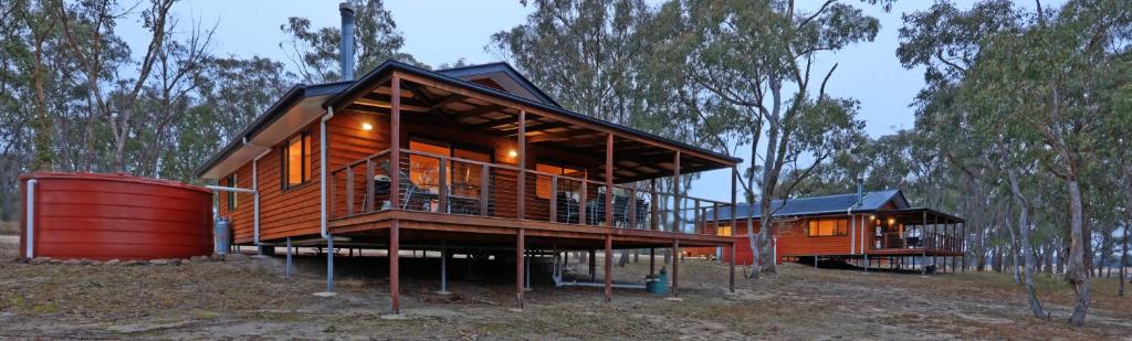 a large wooden house in the middle of a forest at Tiny Away Escape at Granite Belt - Sommerville Valley in Stanthorpe