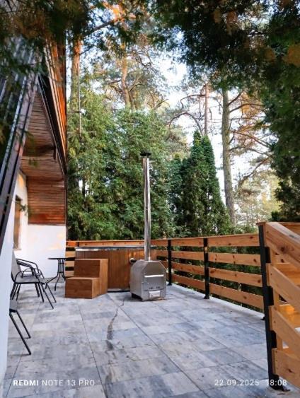 a outdoor patio with a stove on a patio at Domek Chatka Czubatka in Bocheniec