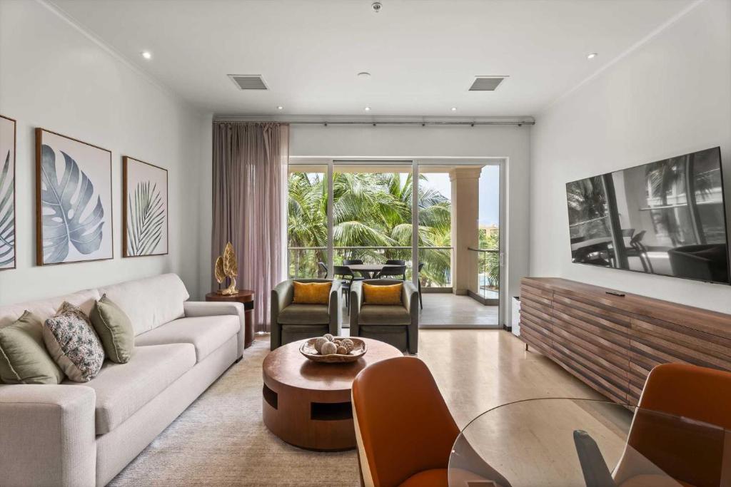 a living room with a couch and a table at Eagle Beach - Palm by the Sea 2BR condo - LV207 in Palm-Eagle Beach