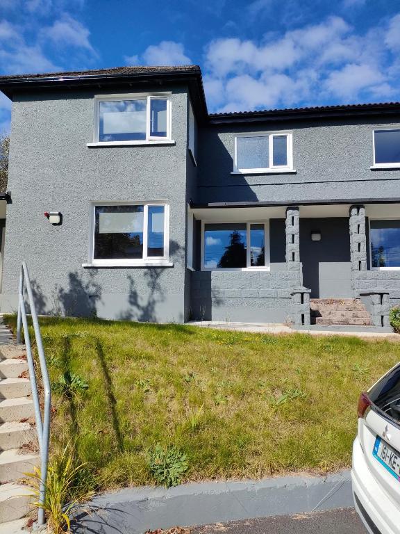 a house with a car parked in front of it at Direct Travel Stays in Cork