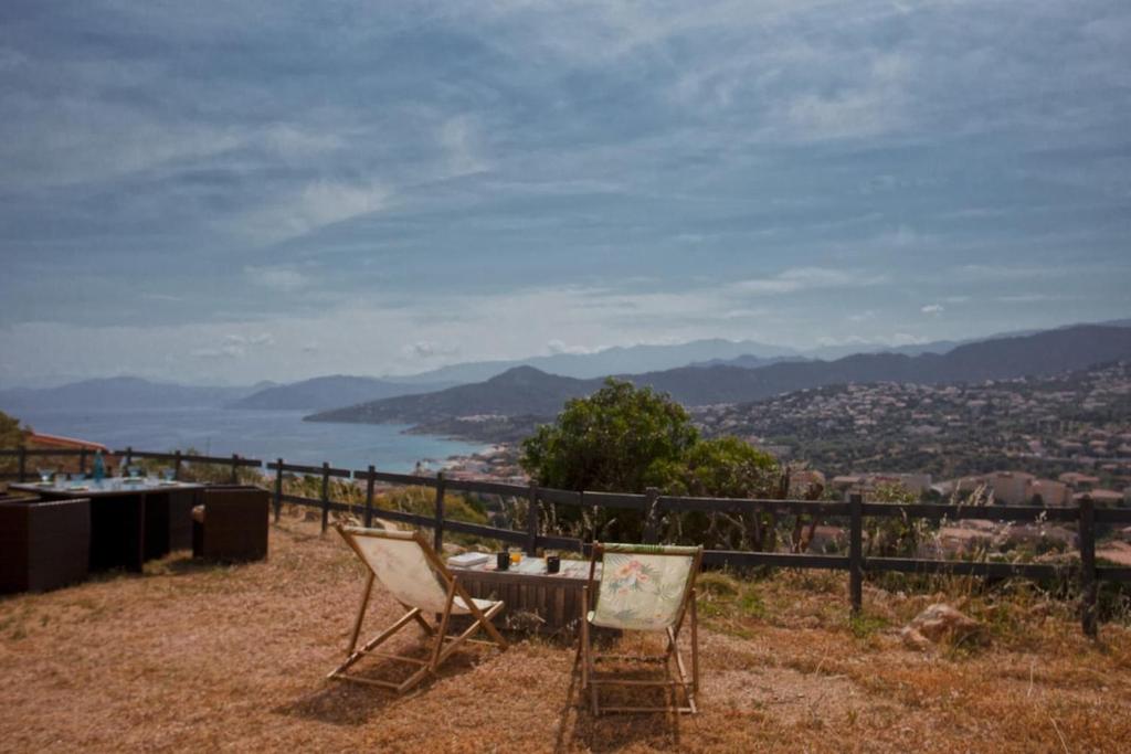 a table and chairs sitting on top of a hill at Casa Bianca in LʼÎle-Rousse