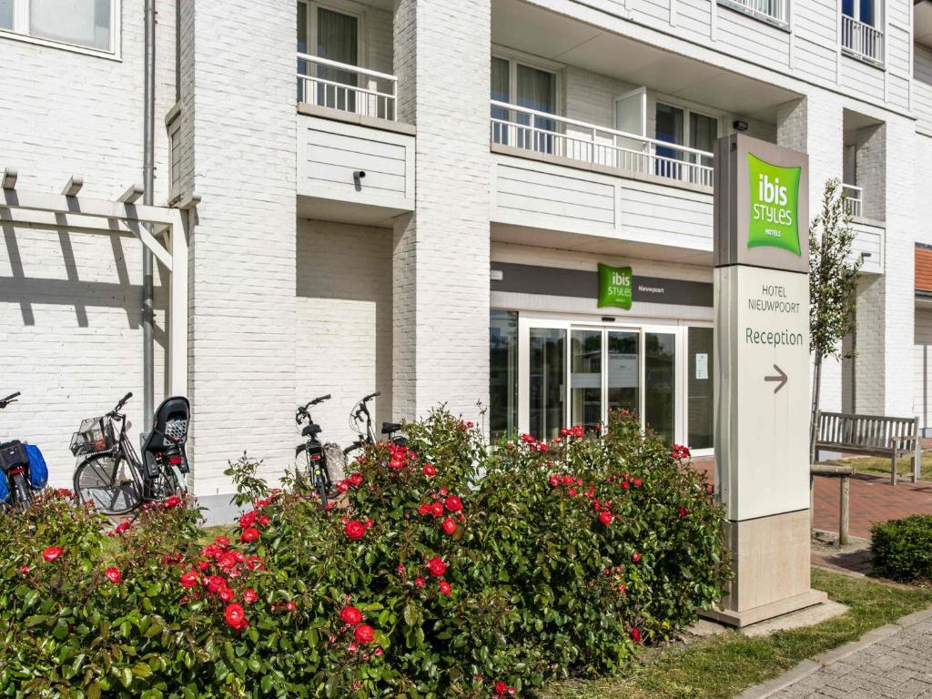 a building with bikes parked outside of a building at ibis Styles Nieuwpoort in Nieuwpoort