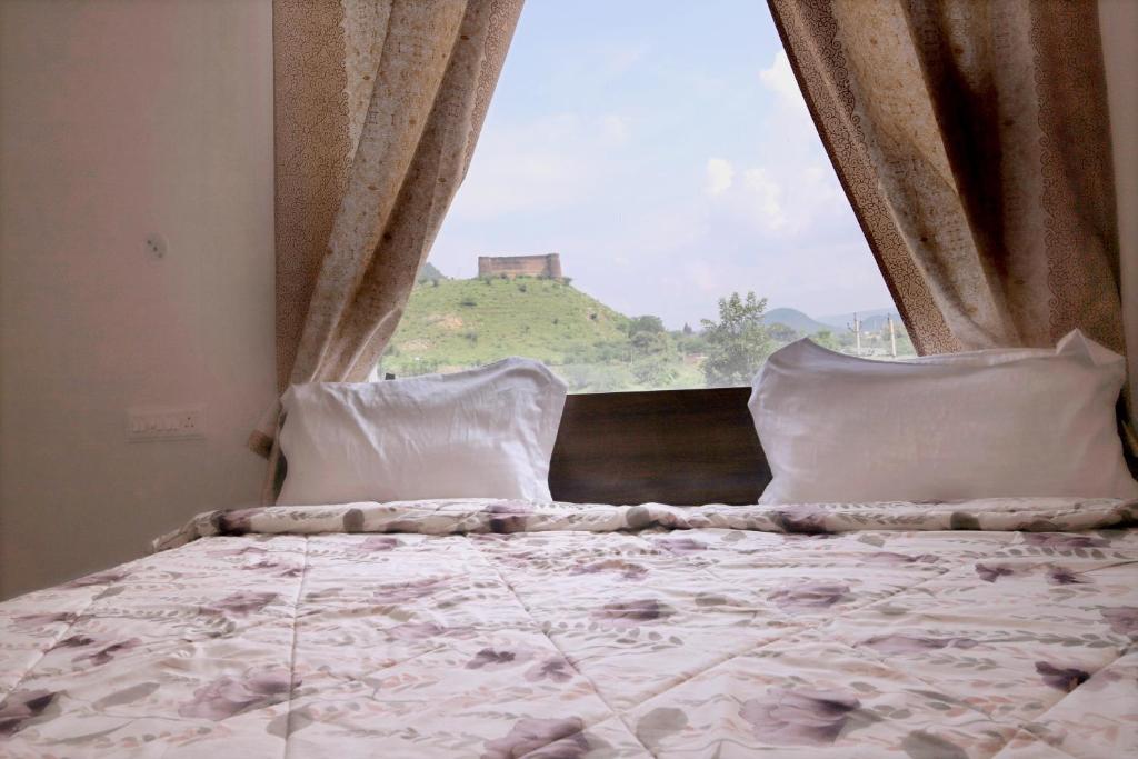 a bedroom with a bed with a large window at Narayani Bag Resort & Restaurant 