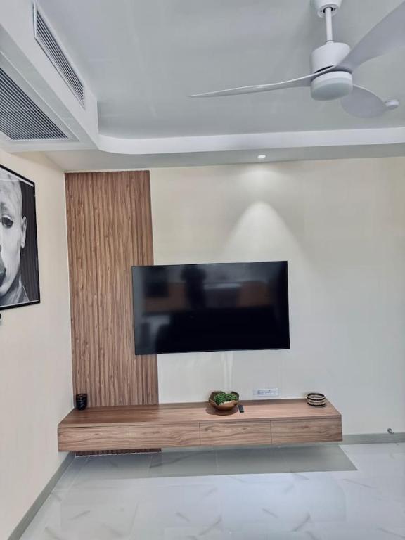 a flat screen tv on a wall in a living room at The Nest At Paradisiac in Ocho Rios