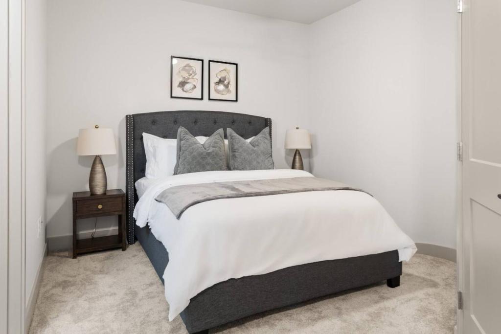Wilders GroveにあるThe Luxe Living 5 Min From Downtownの大きなベッドと2つのランプがある寝室