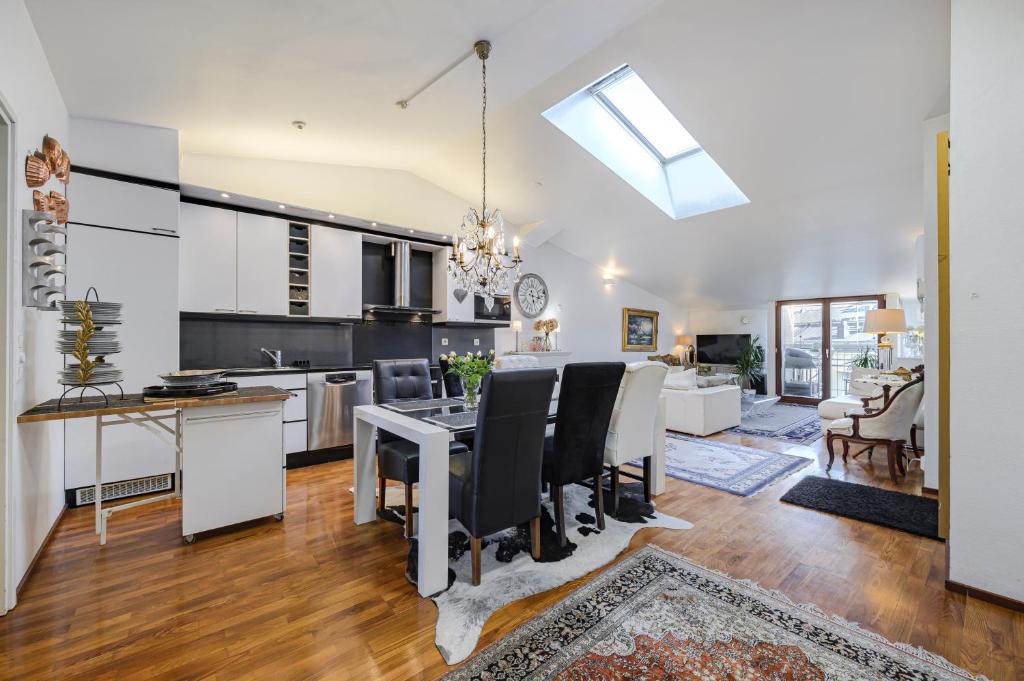 a kitchen and living room with a table and chairs at Modern flat in the citycenter Helsinki in Helsinki