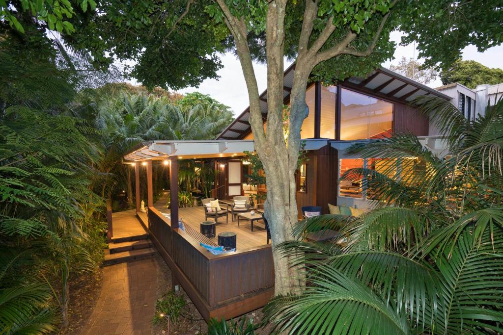 a house in the middle of a forest with a tree at Arajilla Retreat in Lord Howe