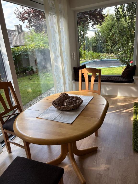 a wooden table and chairs in a room with a window at Traumhafte Gartenwohnung in Pfaffenhofen an der Ilm