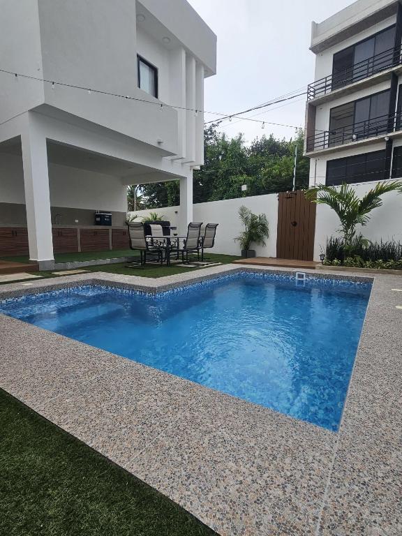 a swimming pool in front of a house at Privada Huayacan in Cancún