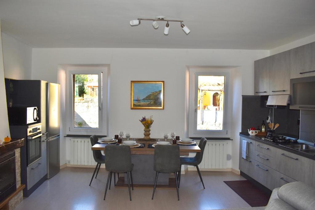 a kitchen with a table and chairs in a kitchen at Lago di Lugano - Casa Cecilia in Lavena Ponte Tresa
