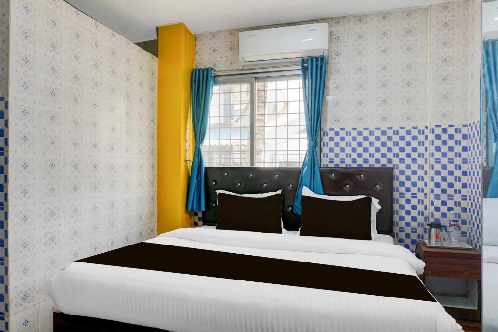 Ένα ή περισσότερα κρεβάτια σε δωμάτιο στο Hotel O Corporate Stay