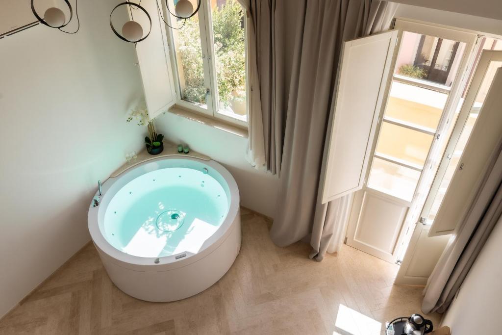 a bathroom with a toilet in a room with a window at Marmori Suites Cagliari in Cagliari