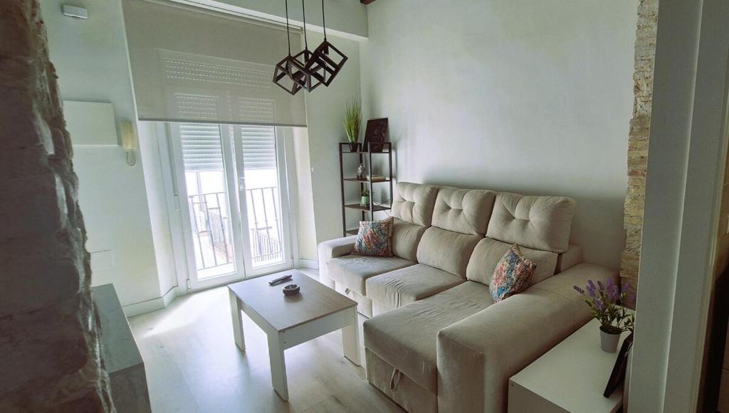 a living room with a couch and a table at Ático de Goleta by Gades Gestión in Cádiz