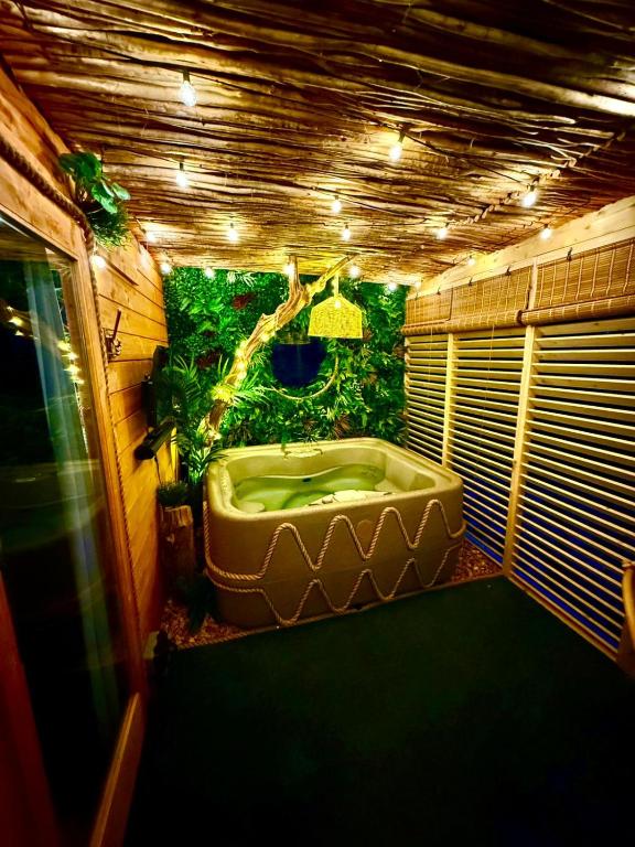 a bathroom with a large bath tub with a tree at Woodland Escapes Glamping - Lake View 