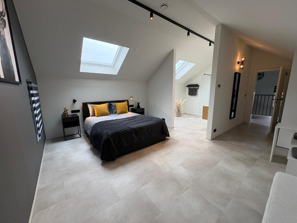 a bedroom with a bed in the middle of a room at Le loft du coiffeur in Érezée