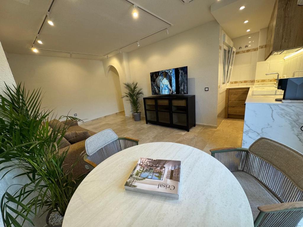 a room with a table with a magazine on it at Atico Benahavis in Benahavís