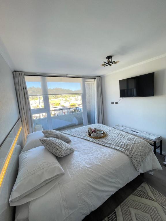Ένα ή περισσότερα κρεβάτια σε δωμάτιο στο Apartamento en Concepcion con estacionamiento privado