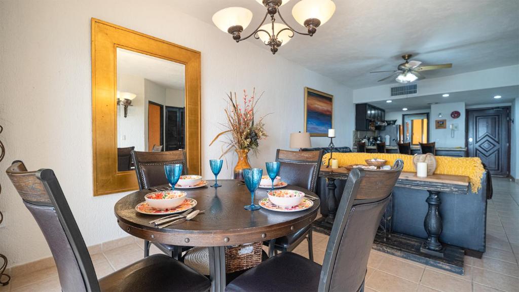 a dining room with a wooden table and chairs at Princesa De Penasco in Punta Penasco New