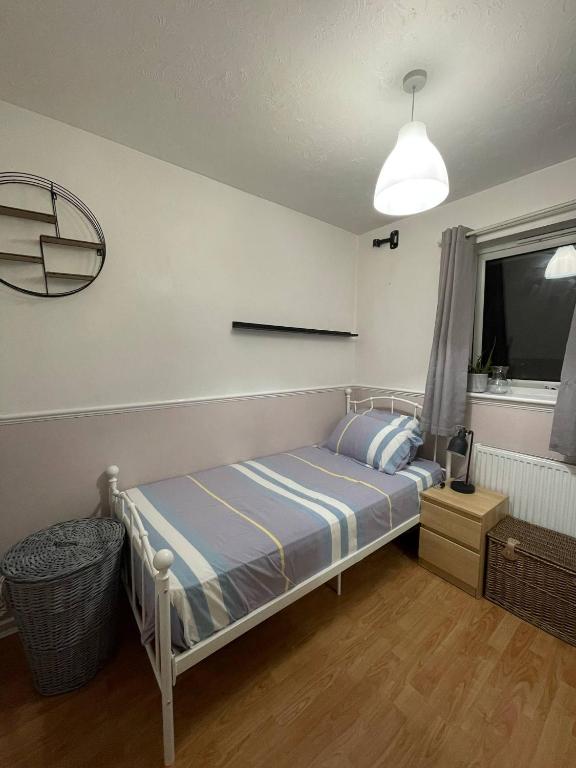 a small bedroom with a bed and a window at Affordable Single Room in Saltney