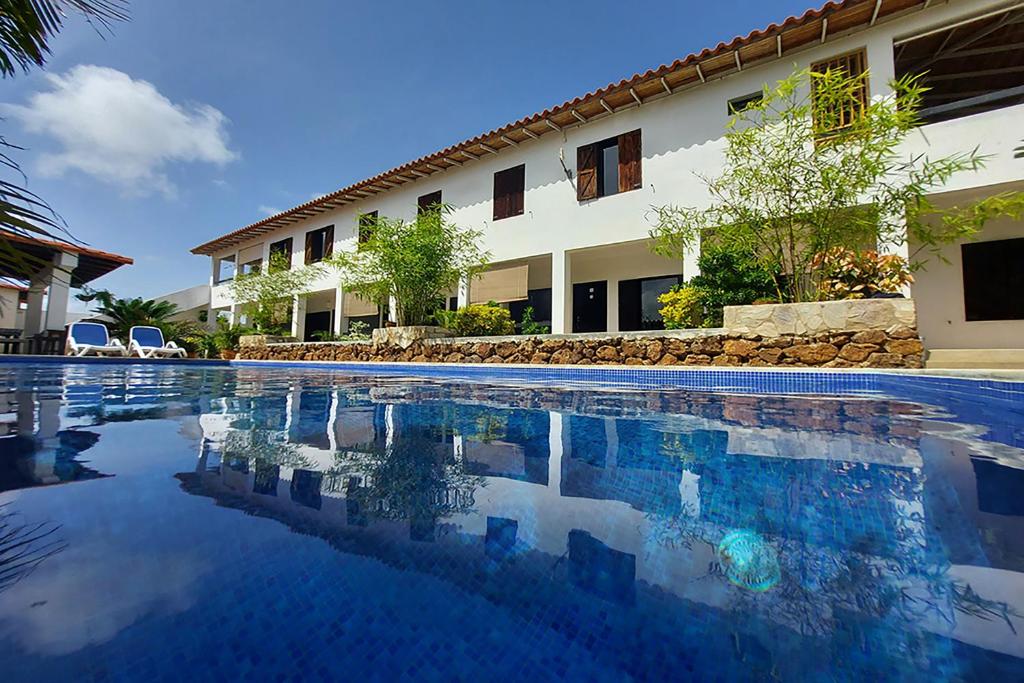 a swimming pool in front of a building at Casa Caribe el Yaque in El Yaque