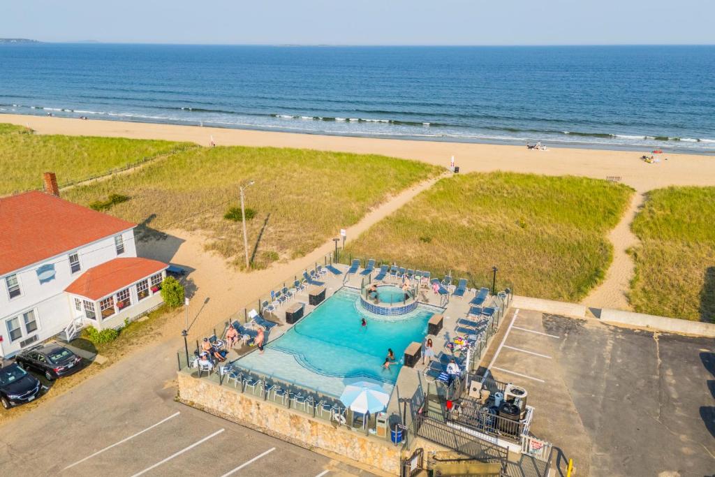 an overhead view of a swimming pool next to a beach at Waves Oceanfront Resort in Old Orchard Beach