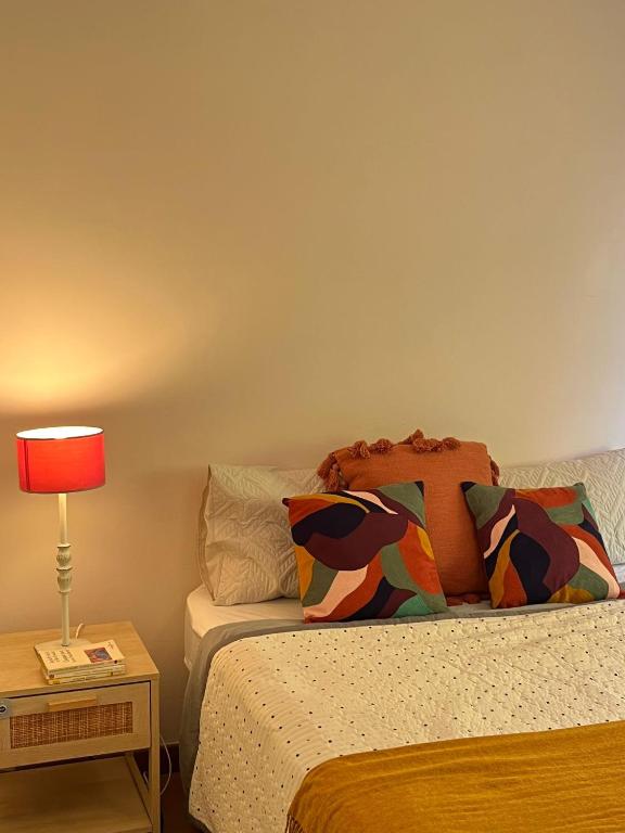a bedroom with a bed and a table with a lamp at Agréables Chambres Centre-Ville Aix in Aix-en-Provence