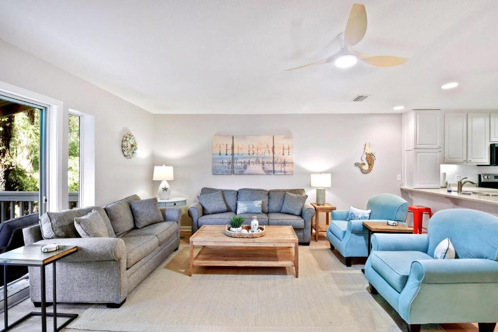 a living room with two couches and a table at Salt Shack in Saint Simons Island
