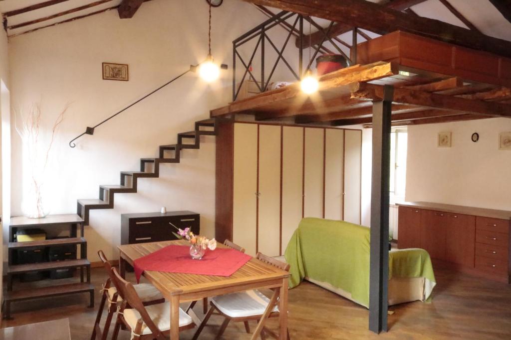 a living room with a table and a loft at Biker house in Ronciglione