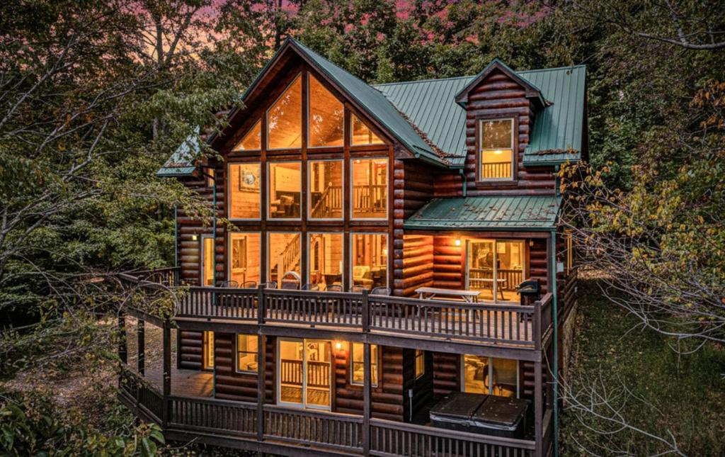 a log cabin with a green roof at Majestic Manor - Peaceful Modern Cabin Retreat Near Watauga Lake in Butler